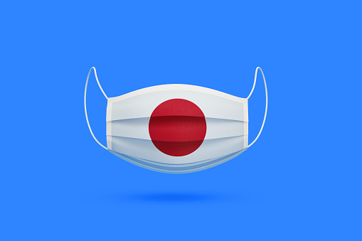 Surgical mask textured with Japanese flag over blue background, Horizontal composition. Illness prevention concept.