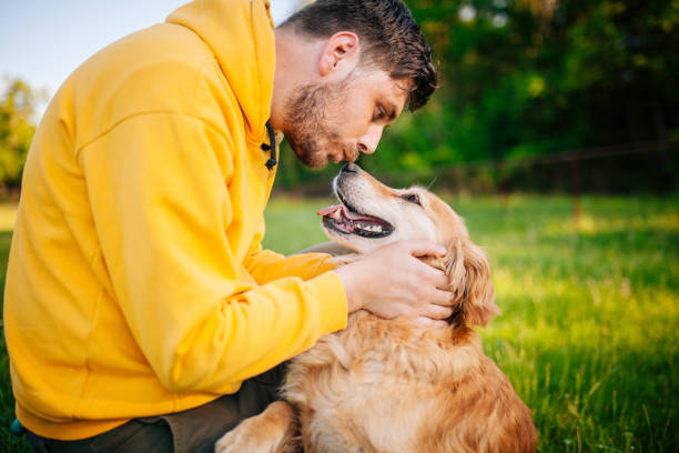 istock Young Man Having Fun With His Dogs 1253506238