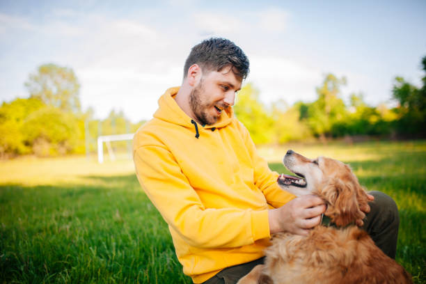 istock Young Man Having Fun With His Dogs 1253506324