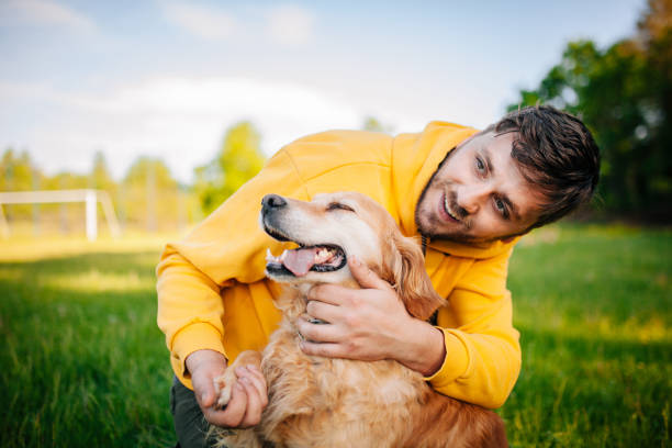istock Young Man Having Fun With His Dogs 1253506502