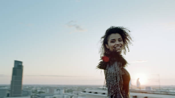 istock Mixed race, seductive woman on a rooftop. Flirting with camera 1253506636