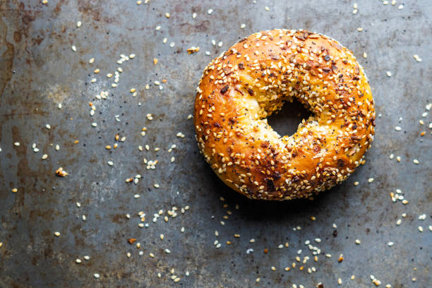 Bread Bagel with everything seasoning grain and cereal products stock pictures, royalty-free photos & images