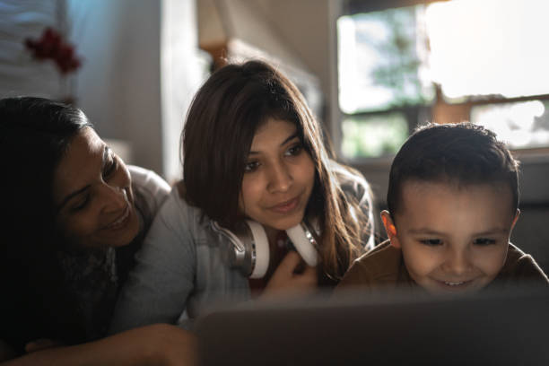 istock Family using laptop together at home 1253510483