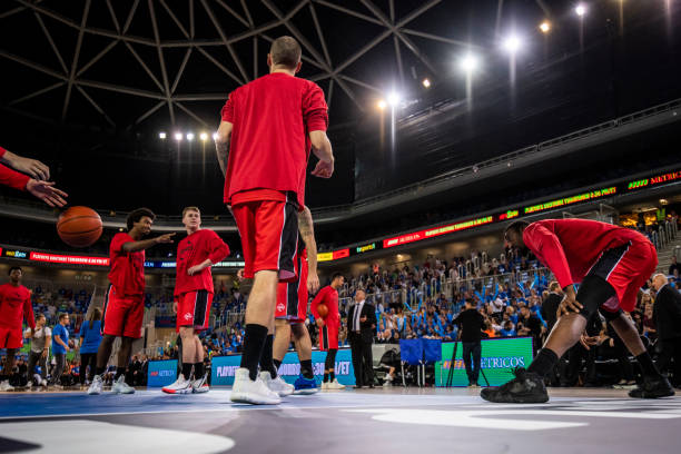 istock Basketball players warming up on court 1253511454