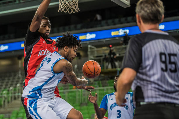 istock Basketball players tackling for ball 1253511510