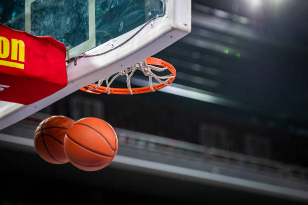 istock Basketballs going through hoop 1253511960