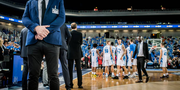 istock Security person standing on basketball court 1253512012