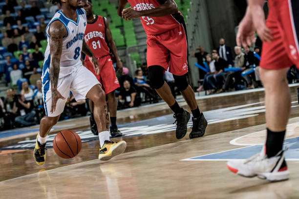 istock Basketball players chasing for ball 1253512014