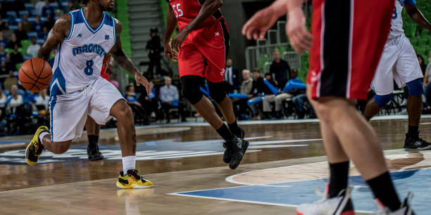 istock Basketball players tackling for ball 1253512052
