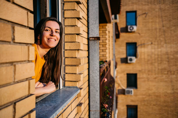 istock Woman enjoying in sun at window 1253513984