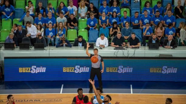 istock Basketball players tackling for ball 1253514074