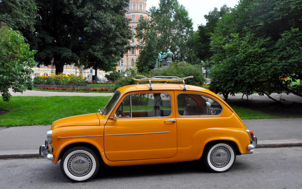 Beautiful restored orange Fiat 500 classic car in Helsinki, Finland Beautiful restored orange small Fiat 500 classic car in Helsinki, Finland little fiat car stock pictures, royalty-free photos & images