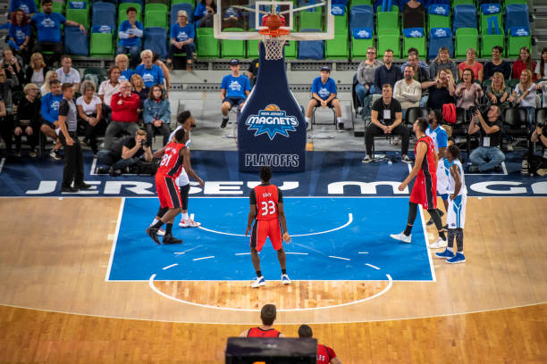 istock Basketball player slam dunking ball 1253514182