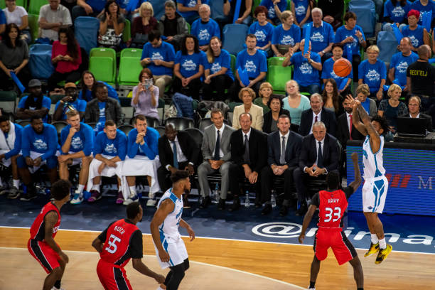 istock Basketball players tackling for ball 1253515332