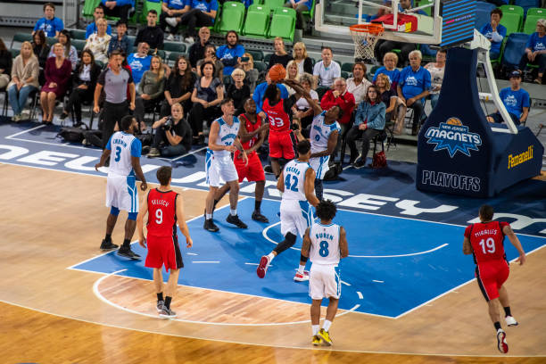 istock Basketball players tackling for ball 1253515336