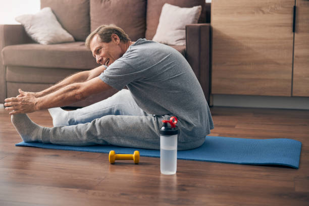 istock Cheerful male person working at his flexibility 1253516706