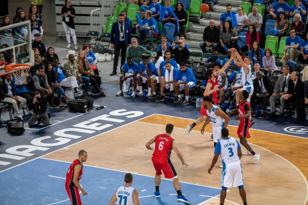 istock Basketball players tackling for ball 1253516769