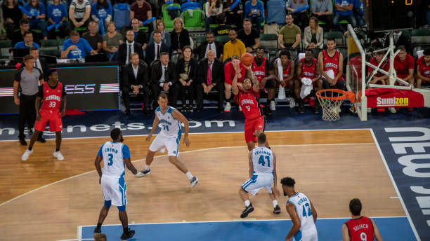 istock Basketball players tackling for ball 1253517143