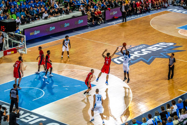 istock Basketball players tackling for ball 1253517151