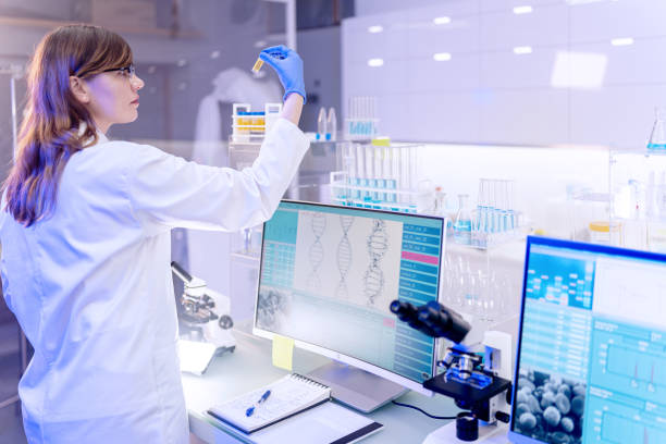 istock Female scientists typing on computer keyboard. Monitors with DNA study in background 1253517166