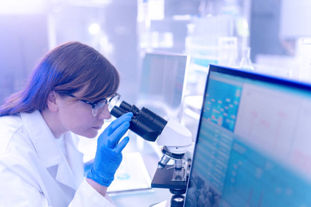 istock Female scientists typing on computer keyboard. Monitors with DNA study in background 1253517266