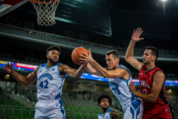 istock Basketball players tackling for ball 1253518069