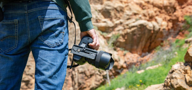 istock traveler hand photo camera in nature 1253518122