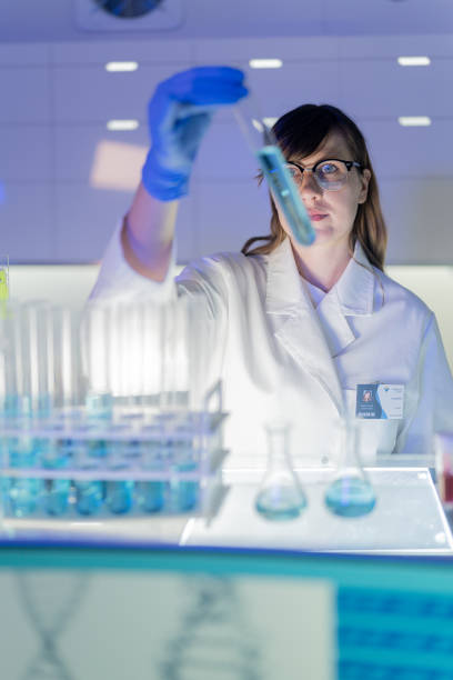 istock Female scientists typing on computer keyboard. Monitors with DNA study in background 1253518163