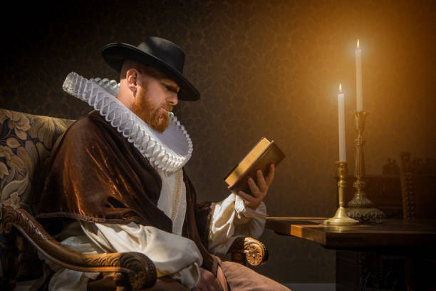 istock Redhead traditional dutch man reading a book by candlelight 1253518198