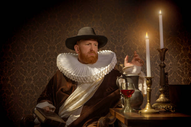 istock Redhead traditional dutch man reading a book by candlelight 1253518227