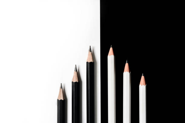 flat lay composition with white and black color cards. Pencils lie in a row on a black and white background with a copy space. Back to school concept