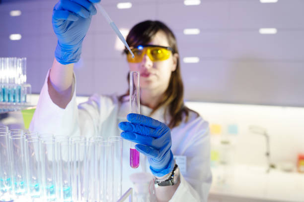 Scientist Reaching For Bottle Containing Ingredient Needed To Make Compound