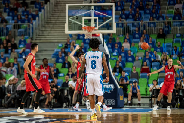 istock Basketball players tackling for ball 1253518314