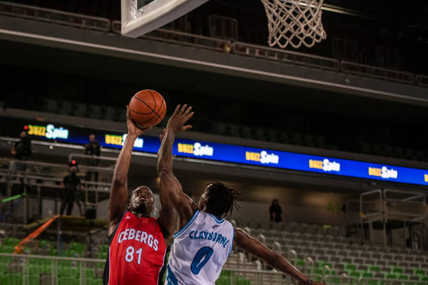 istock Basketball players tackling for ball 1253518317