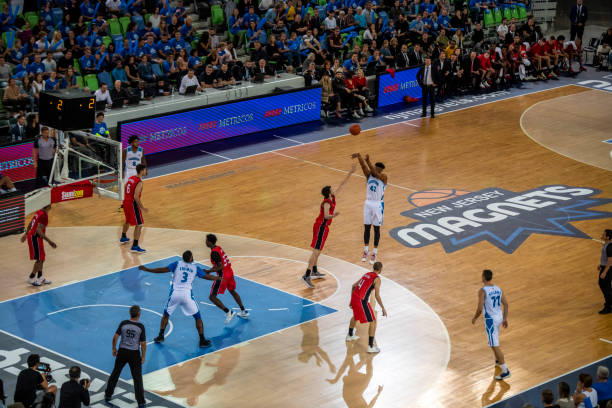 istock Basketball players tackling for ball 1253518318