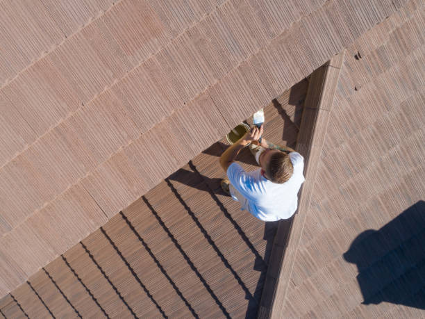 istock Professional Painter Using A Brush to Paint House Fascia 1253519092