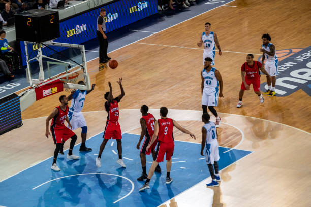 istock Basketball players playing on court 1253519232
