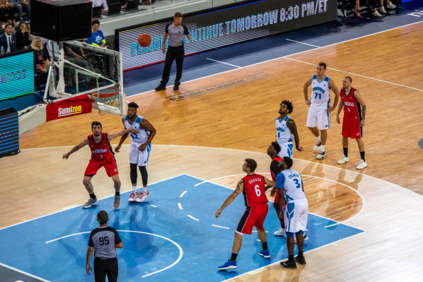 istock Basketball player aiming ball for hoop 1253519398