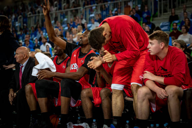 istock Basketball players and coach sitting on bench 1253519765
