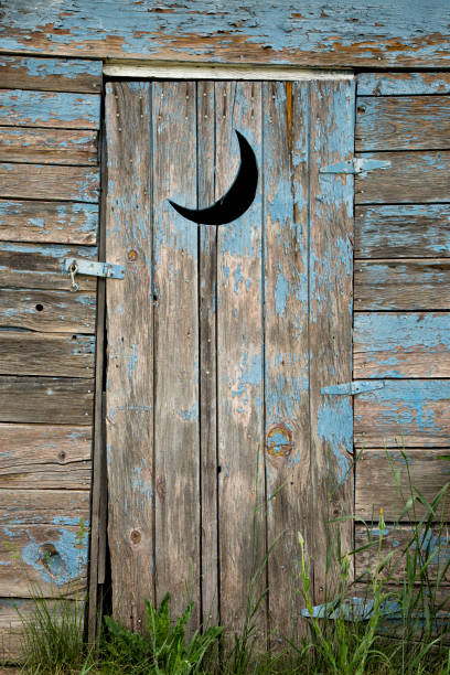 Weathered Outhouse An old, weathered outhouse door comes complete with the standard moon cutout. Outhouse stock pictures, royalty-free photos & images