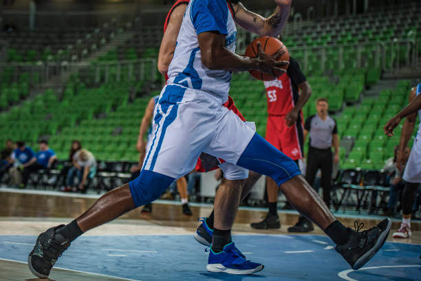 istock Basketball players tackling for ball 1253521303