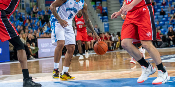 istock Basketball players tackling for ball 1253521445