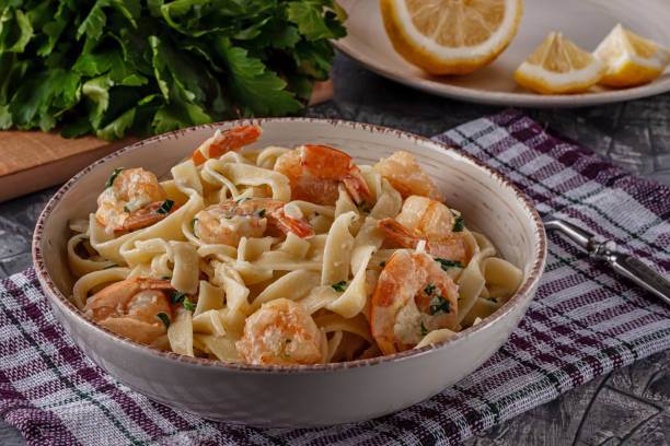 istock Tagliatelle with prawns and parsley on a gray background 1253522325