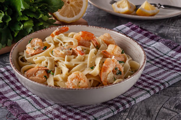 istock Tagliatelle with prawns and parsley on a gray background 1253522327