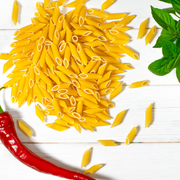 istock Cooking vegetarian penne pasta from organic products 1253523812