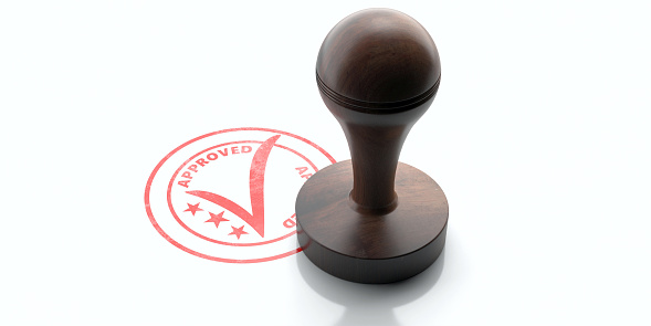 APPROVED stamp. Wooden round rubber stamper and stamp with text approved isolated on white background. 3d illustration
