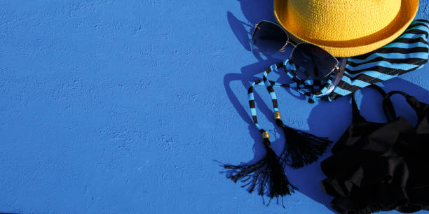 istock Women's accessories for a beach holiday on a blue background. 1253529426