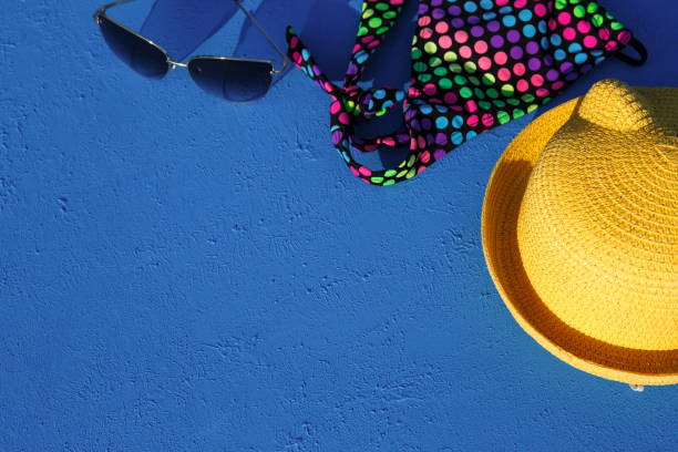istock Women's accessories for a beach holiday on a blue background. 1253529445
