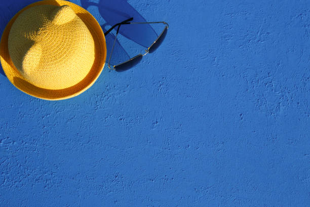 istock Women's accessories for a beach holiday on a blue background. 1253529446