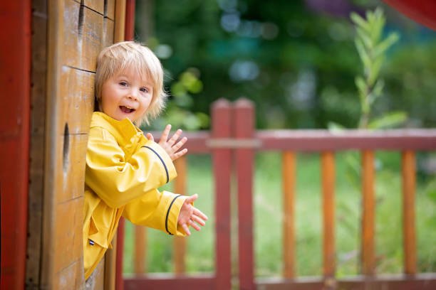 istock Cute child, blond boy, playing on playground on a cloudy day 1253531347